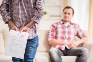 Why Does the School Say He’s Fine When He’s Failing 2 Classes and Barely Passing the Rest? 1 Teenage student looking discouraged at schoolwork