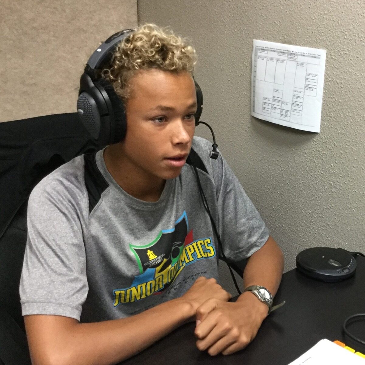 Teen boy wearing headphones and a microphone during auditory processing training at Stowell Learning Center