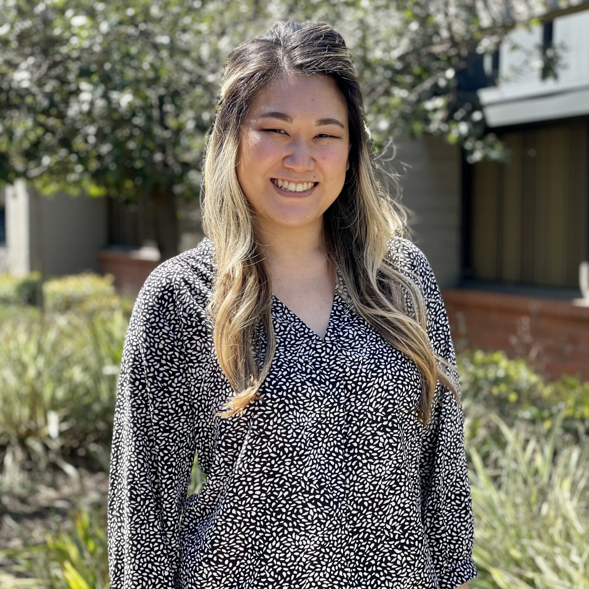 Irvine center director, Chantel Quach, smiling outdoors