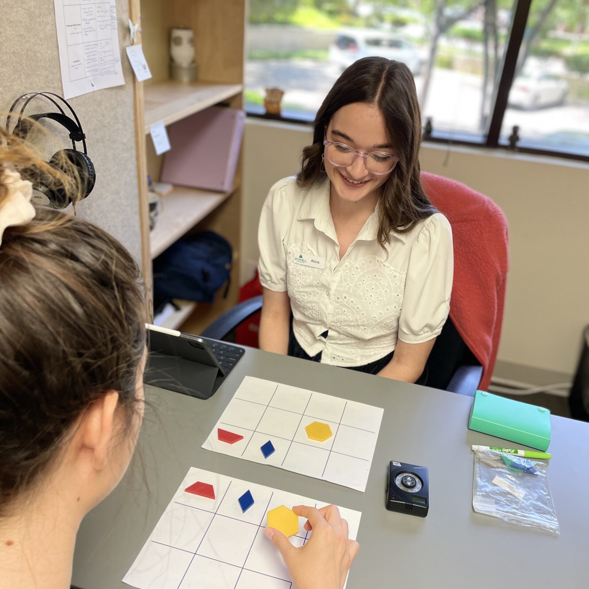 Thousand Oaks clinician watching student arrange symbols in AMPS program