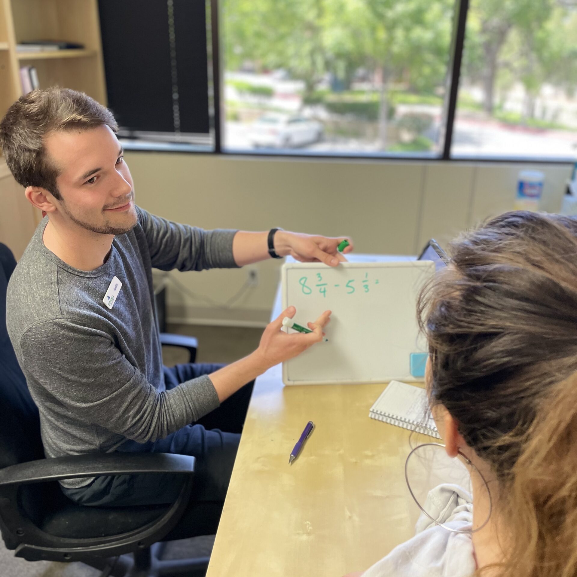 Thousand Oaks clinician holding up white board for Discover Math Program